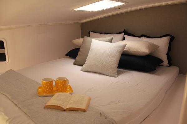 Slide: The Image of Cozy bedroom in 2024 Seawind 1160 Lite with pillows, book, and mugs. - 25