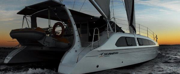 Slide: The Image of 2024 Seawind 1160 Lite catamaran sailing at sunset. - 3