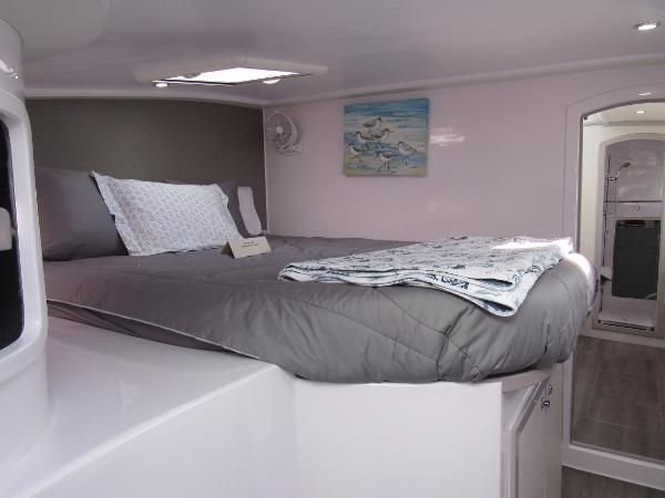 Slide: The Image of 2024 Seawind 1160 Lite interior cabin with bed and modern decor. - 35
