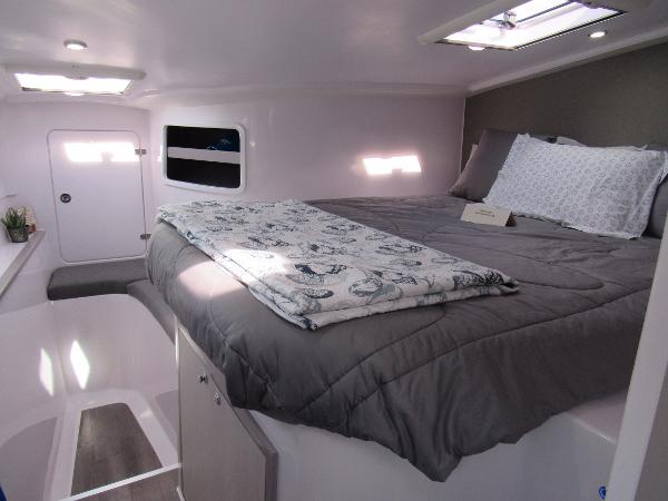 Slide: The Image of Interior cabin of 2024 Seawind 1160 Lite catamaran with cozy bed and skylight. - 36