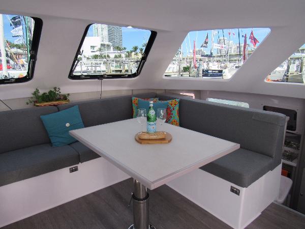 Slide: The Image of Interior of 2024 Seawind 1160 Lite catamaran with modern seating and table. - 39