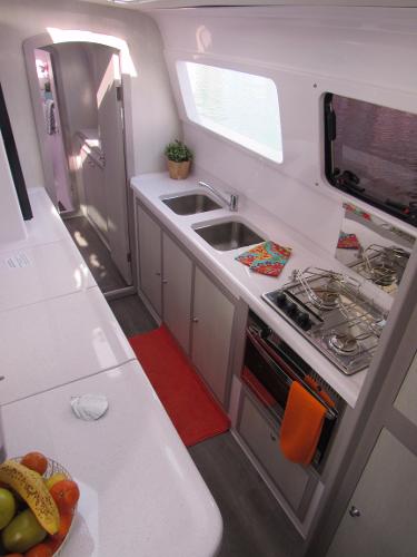 Slide: The Image of Modern kitchen in 2024 Seawind 1160 Lite catamaran with dual sinks and gas stove. - 41