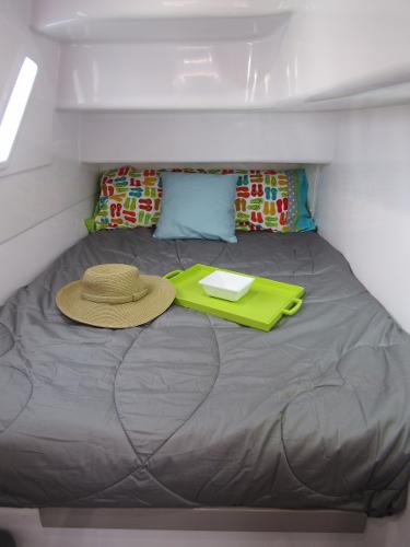 Slide: The Image of Cozy cabin interior of 2024 Seawind 1160 Lite with bed, hat, and tray. - 44