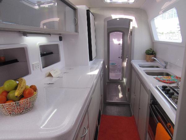Slide: The Image of 2024 Seawind 1160 Lite yacht kitchen with modern appliances and fruit basket. - 45