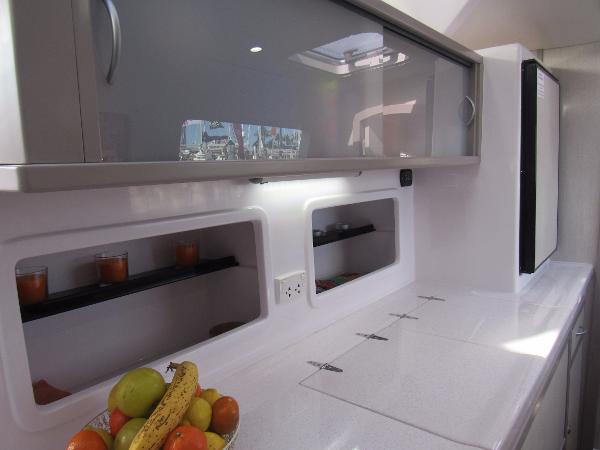 Slide: The Image of Modern kitchen interior of 2024 Seawind 1160 Lite catamaran with fruit bowl and sleek cabinets. - 49
