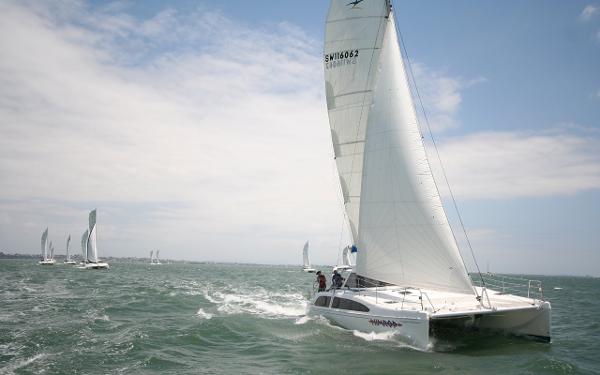 Slide: The Image of 2024 Seawind 1160 Lite catamaran sailing on open water. - 9