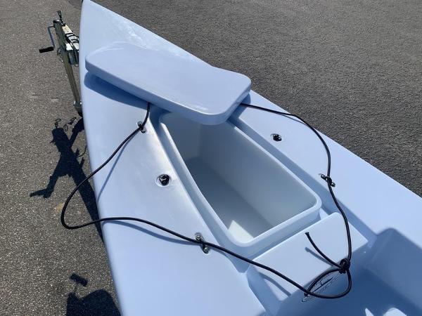 Slide: The Image of 2023 Solo Skiff 14 with open storage compartment on a sunny day. - 10