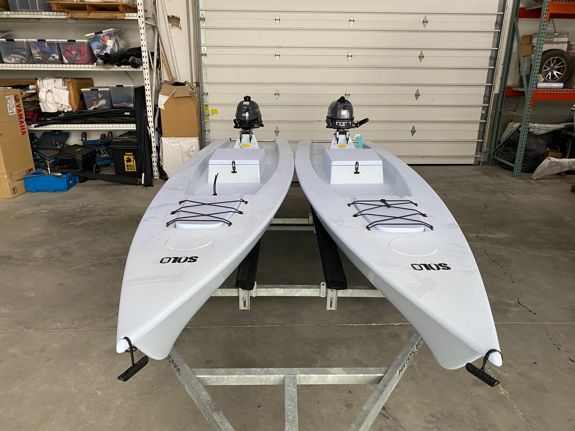 Slide: The Image of Two 2023 Solo Skiff SOLO SKIFF boats with motors in a garage. - 3