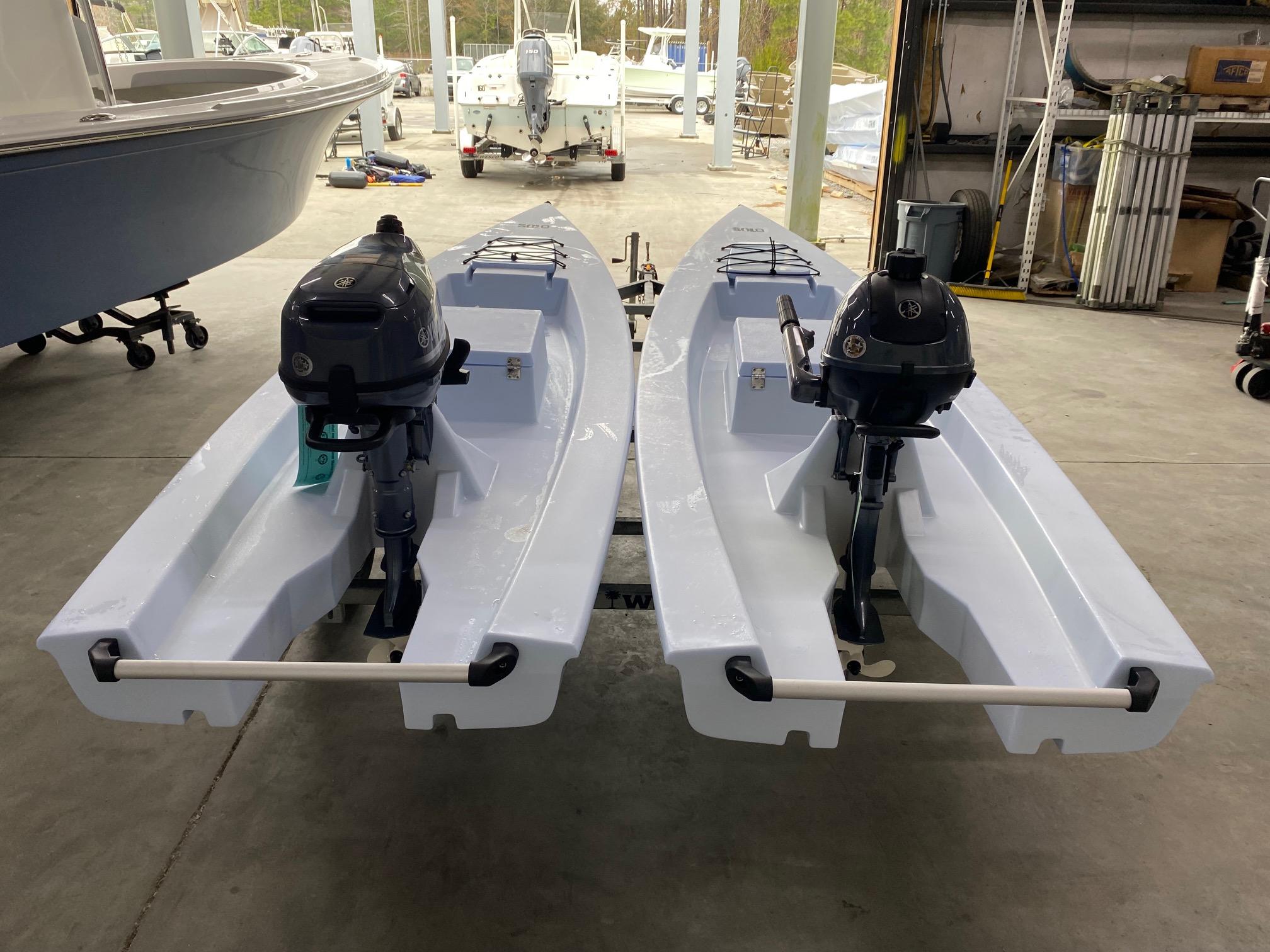 Slide: The Image of 2023 Solo Skiff boats with outboard motors in a storage facility. - 5