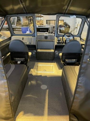 Slide: The Image of 2024 Spartan 185 Astoria boat interior with seating and steering console. - 11