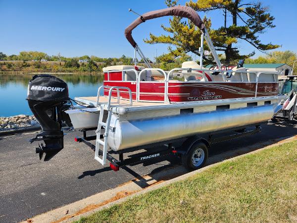 Slide: The Image of 2012 Sun Tracker Party Barge 20 DLX pontoon boat on trailer by a lake. - 1