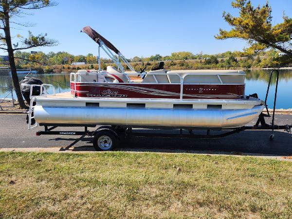 Slide: The Image of 2012 Sun Tracker Party Barge 20 DLX pontoon boat on trailer by a lake. - 10