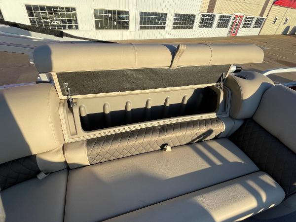Slide: The Image of 2024 Sun Tracker Party Barge 20 DLX storage compartment with cushioned seating. - 2