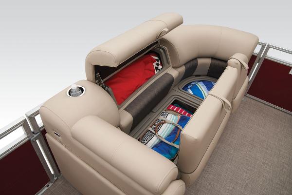 Slide: The Image of 2024 Sun Tracker Party Barge 20 DLX seating with storage compartments filled with gear. - 27
