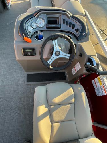 Slide: The Image of 2024 Sun Tracker Party Barge 20 DLX boat dashboard and captain's chair. - 3