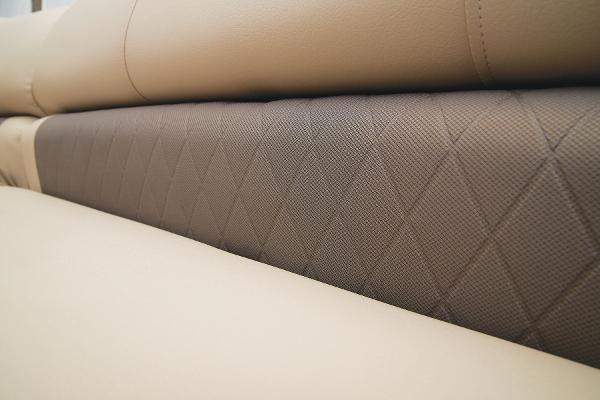 Slide: The Image of Close-up of 2024 Sun Tracker Party Barge 20 DLX beige and brown upholstery. - 31