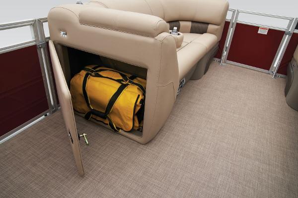 Slide: The Image of 2024 Sun Tracker Party Barge 20 DLX storage compartment with yellow duffel bag. - 32