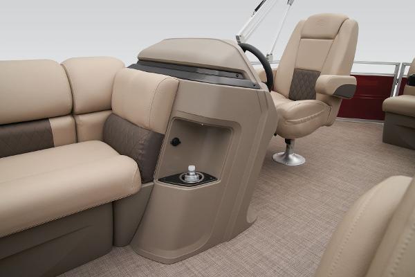 Slide: The Image of 2024 Sun Tracker Party Barge 20 DLX interior with beige seating and steering console. - 33