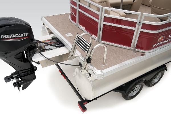 Slide: The Image of 2024 Sun Tracker Party Barge 20 DLX pontoon boat rear view with Mercury outboard motor. - 49