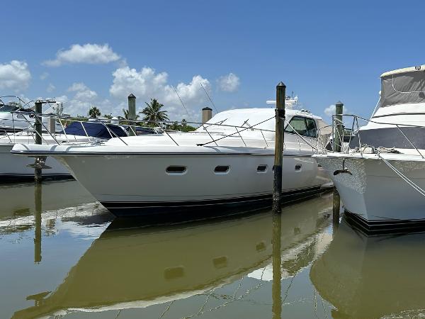 Slide: The Image of 2004 Tiara Yachts 5200 Sovran Salon docked in a marina on a sunny day. - 0