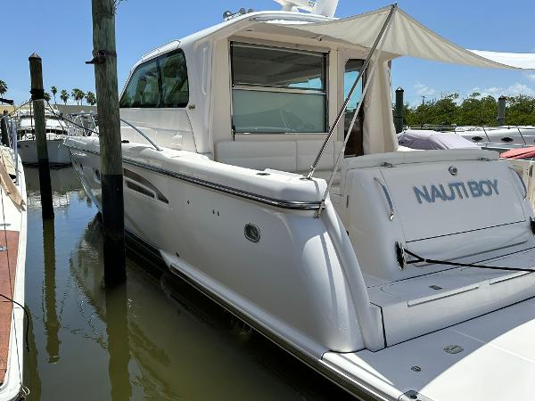 Slide: The Image of 2004 Tiara Yachts 5200 Sovran Salon docked, rear view with NAUTI BOY name. - 1
