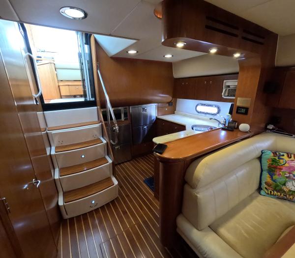 Slide: The Image of Interior of 2004 Tiara Yachts 5200 Sovran Salon with wooden finishes and modern amenities. - 10