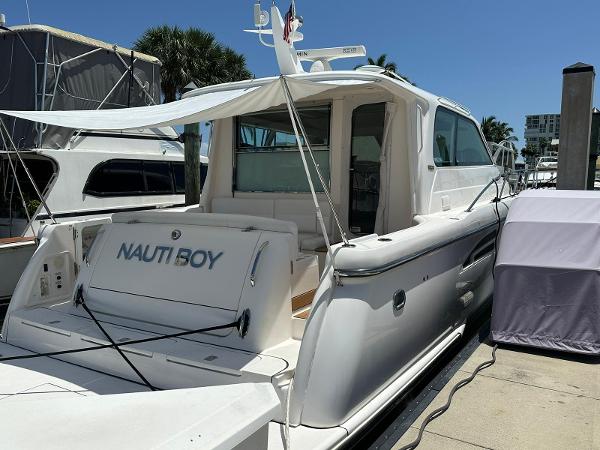 Slide: The Image of 2004 Tiara Yachts 5200 Sovran Salon docked, rear view with Nauti Boy name. - 2
