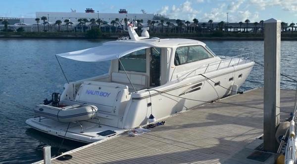 Slide: The Image of 2004 Tiara Yachts 5200 Sovran Salon docked at a marina. - 3
