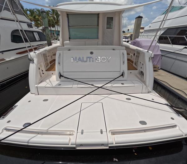 Slide: The Image of 2004 Tiara Yachts 5200 Sovran Salon docked, rear view with NAUTI BOY nameplate. - 4