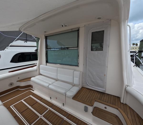 Slide: The Image of 2004 Tiara Yachts 5200 Sovran Salon, rear deck with white seating and wooden flooring. - 6