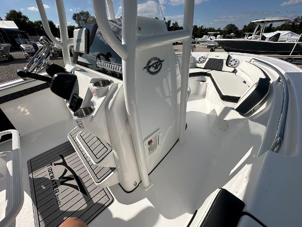 Slide: The Image of 2024 Tidewater 210 CC Adventure boat interior with console and seating. - 23