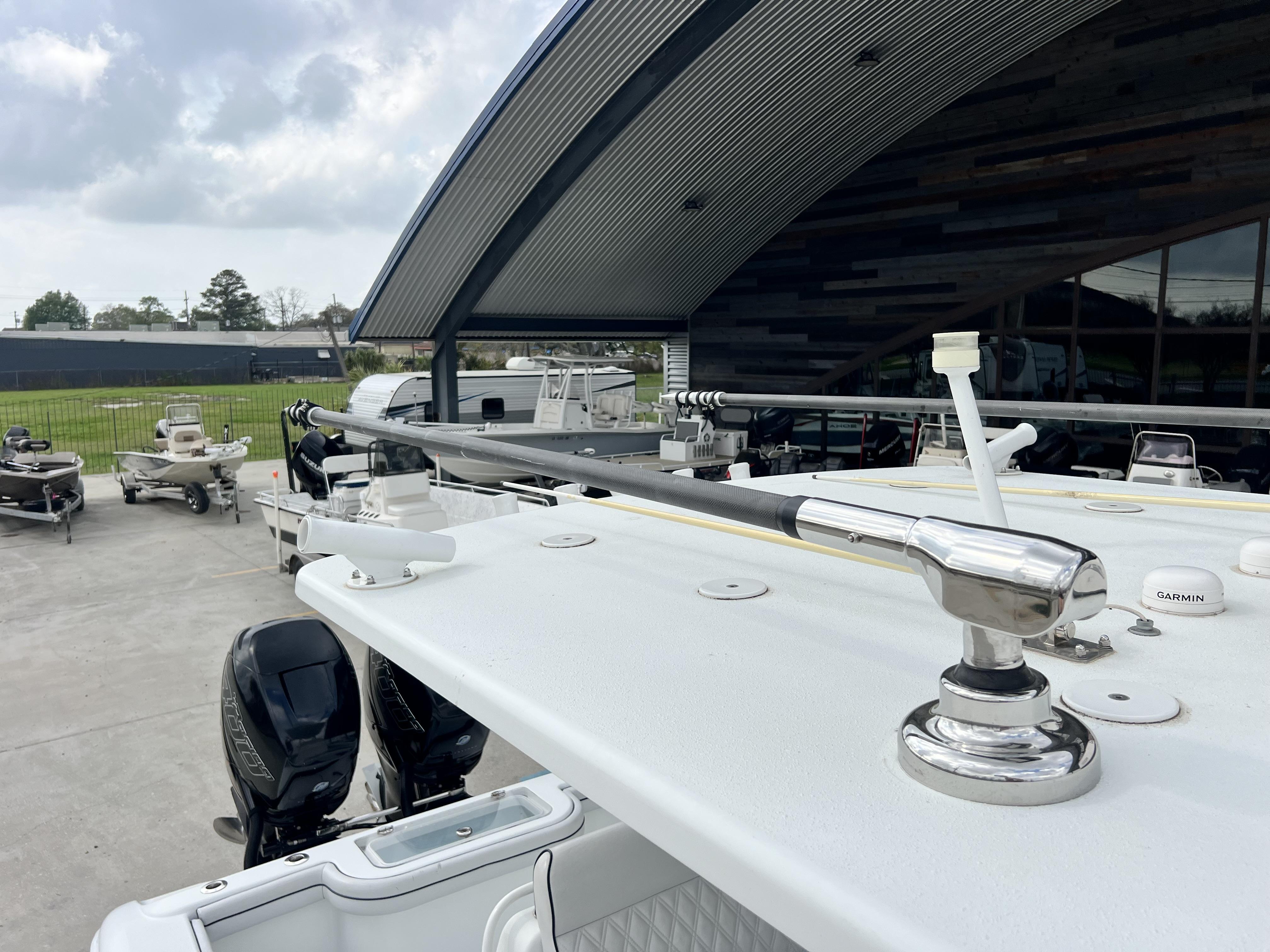 Slide: The Image of 2018 Yellowfin 29 boat with dual outboard motors in a marina. - 13