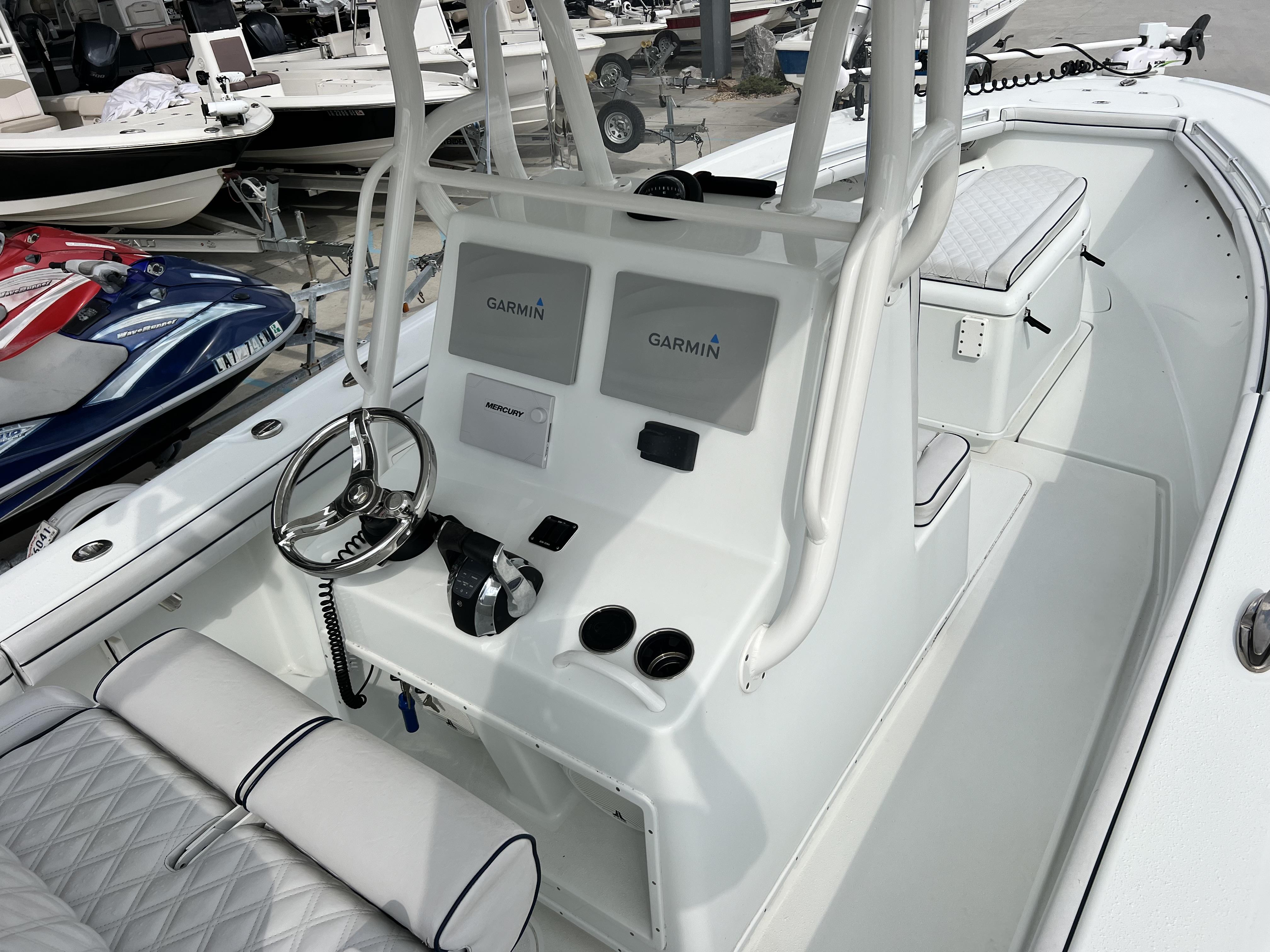 Slide: The Image of 2018 Yellowfin 29 boat interior with Garmin navigation system and Mercury controls. - 14