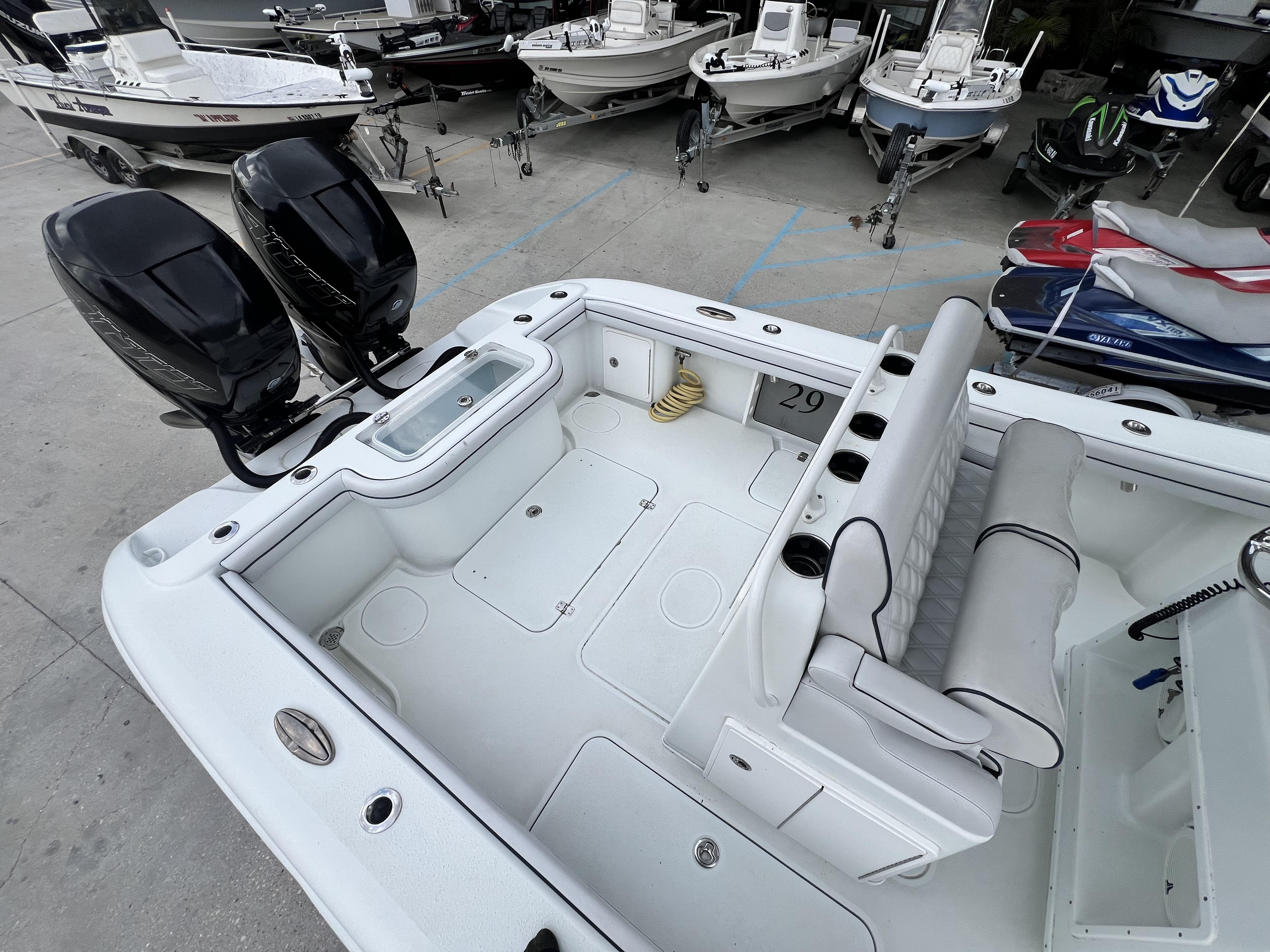 Slide: The Image of 2018 Yellowfin 29 boat with dual outboard motors in a marina. - 19