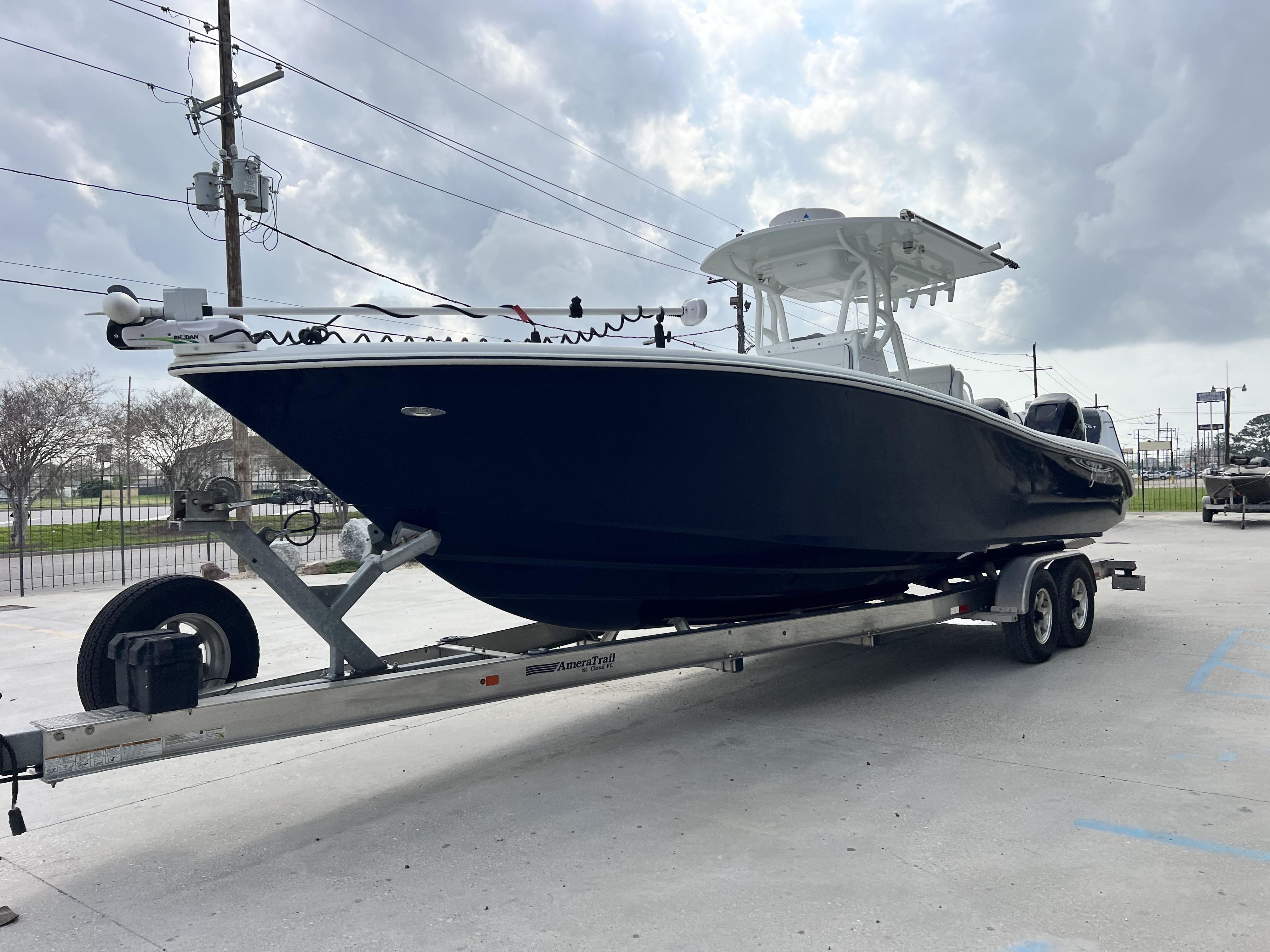 Slide: The Image of 2018 Yellowfin 29 boat on trailer under cloudy sky. - 25