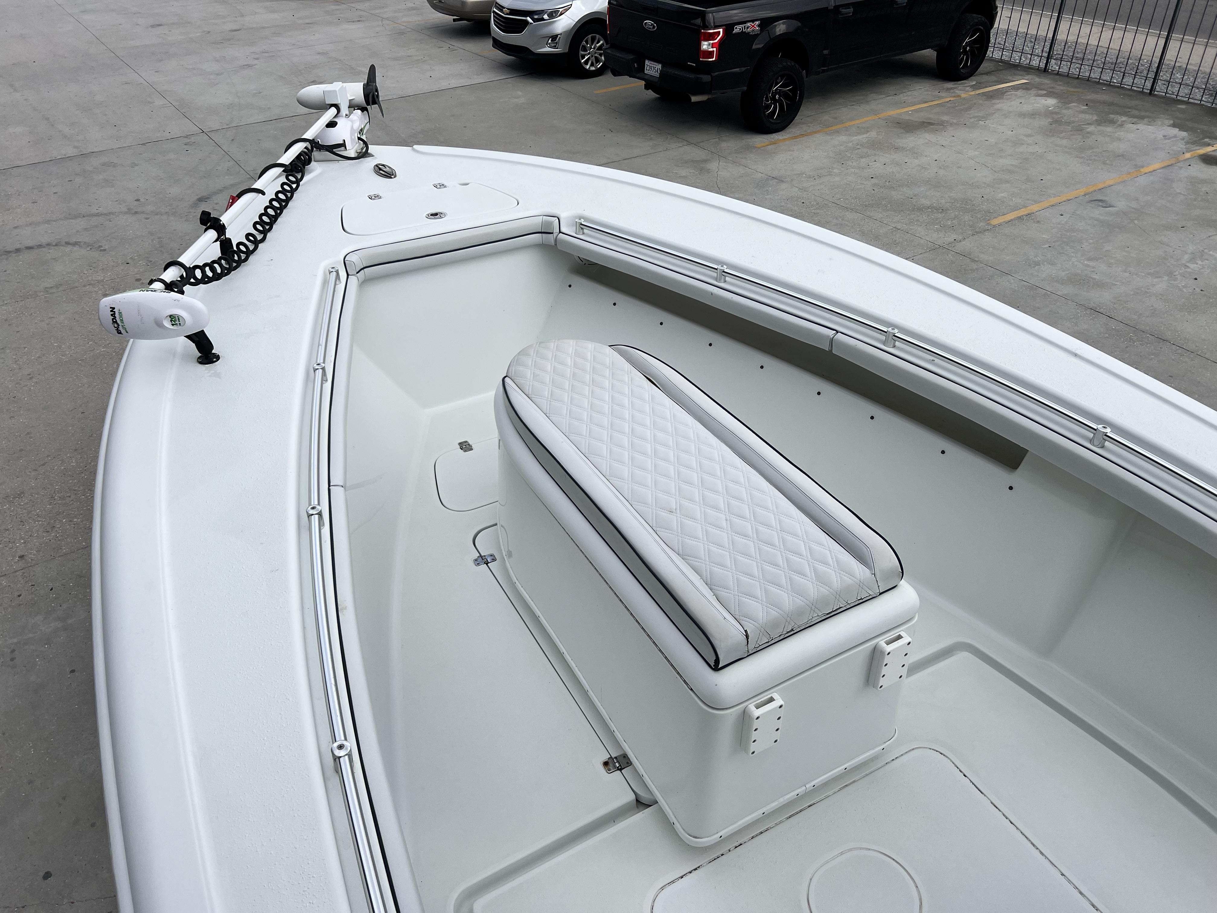 Slide: The Image of 2018 Yellowfin 29 boat with white seating and trolling motor. - 26
