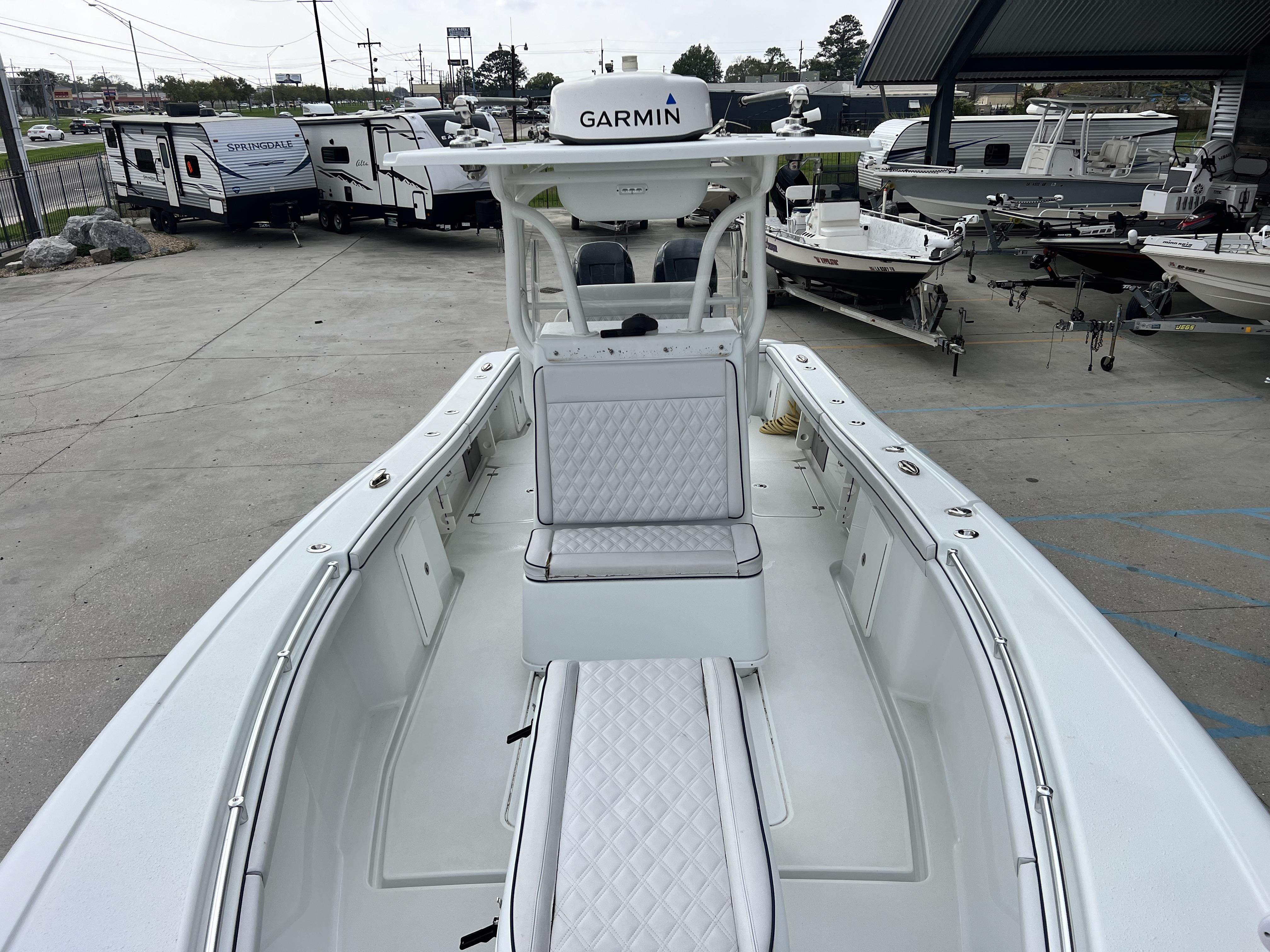 Slide: The Image of 2018 Yellowfin 29 boat with Garmin electronics, docked near RVs and other boats. - 27
