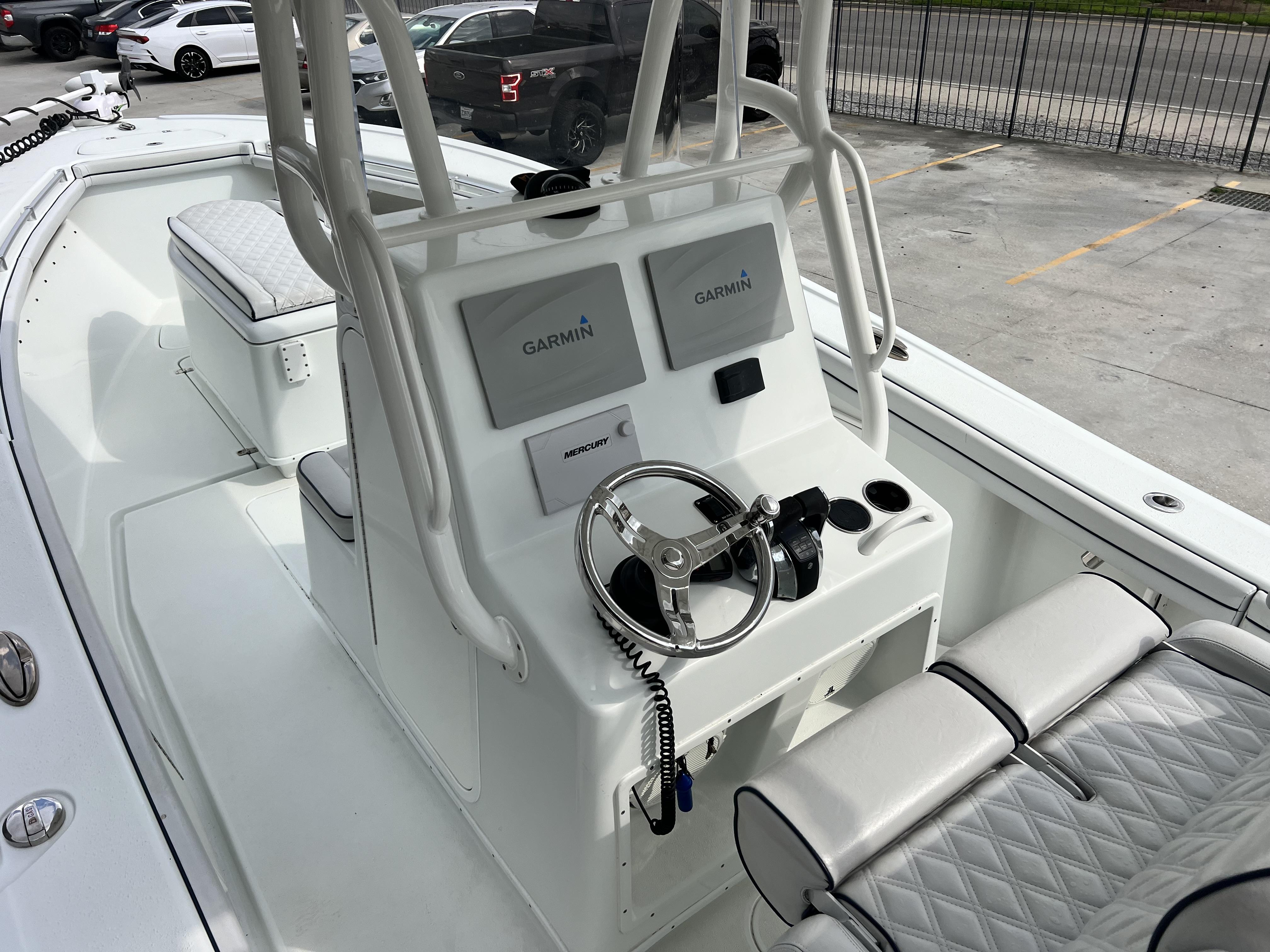 Slide: The Image of 2018 Yellowfin 29 boat interior with Garmin navigation system and Mercury controls. - 29