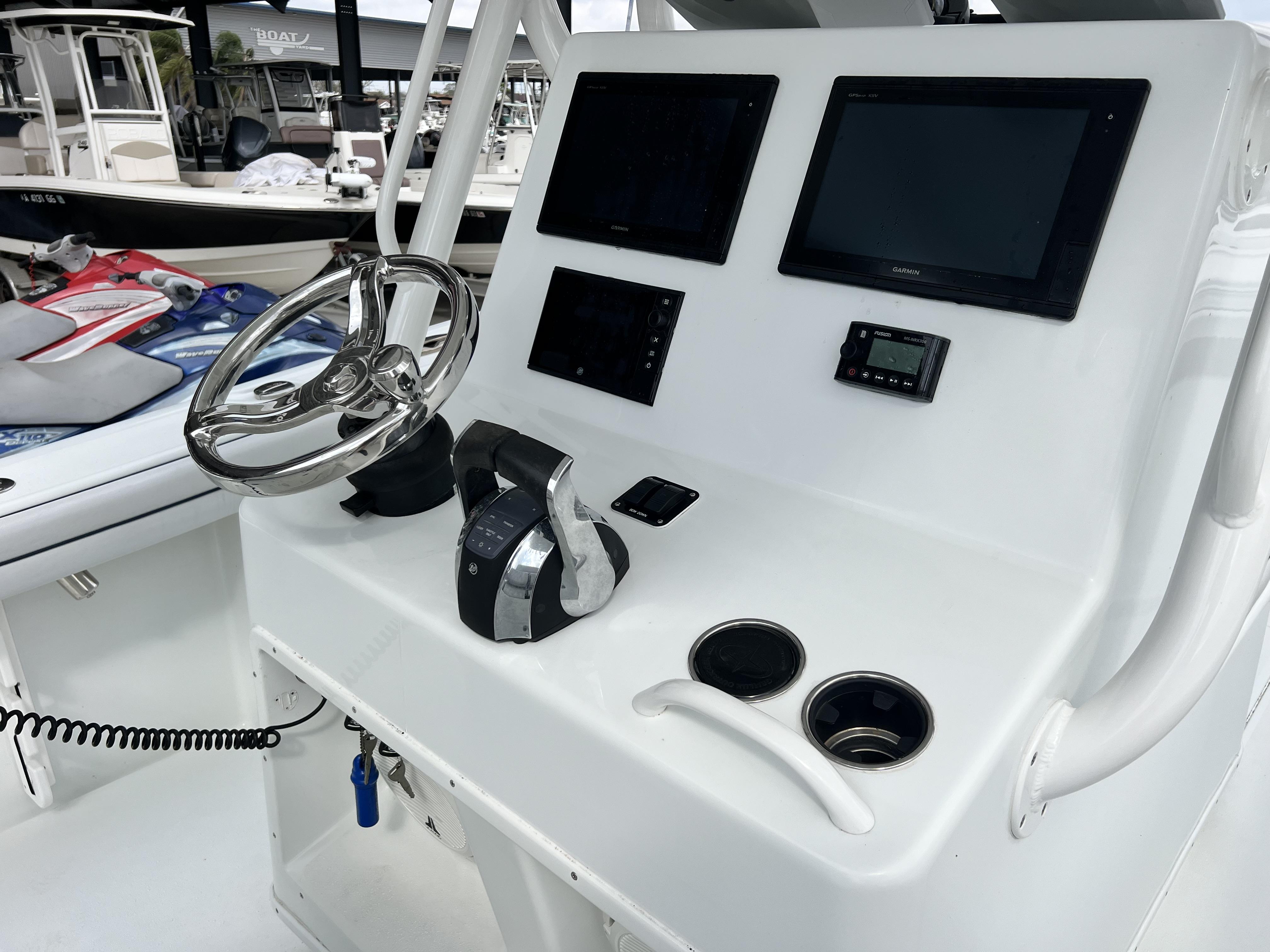 Slide: The Image of 2018 Yellowfin 29 boat dashboard with steering wheel and electronic displays at marina. - 31