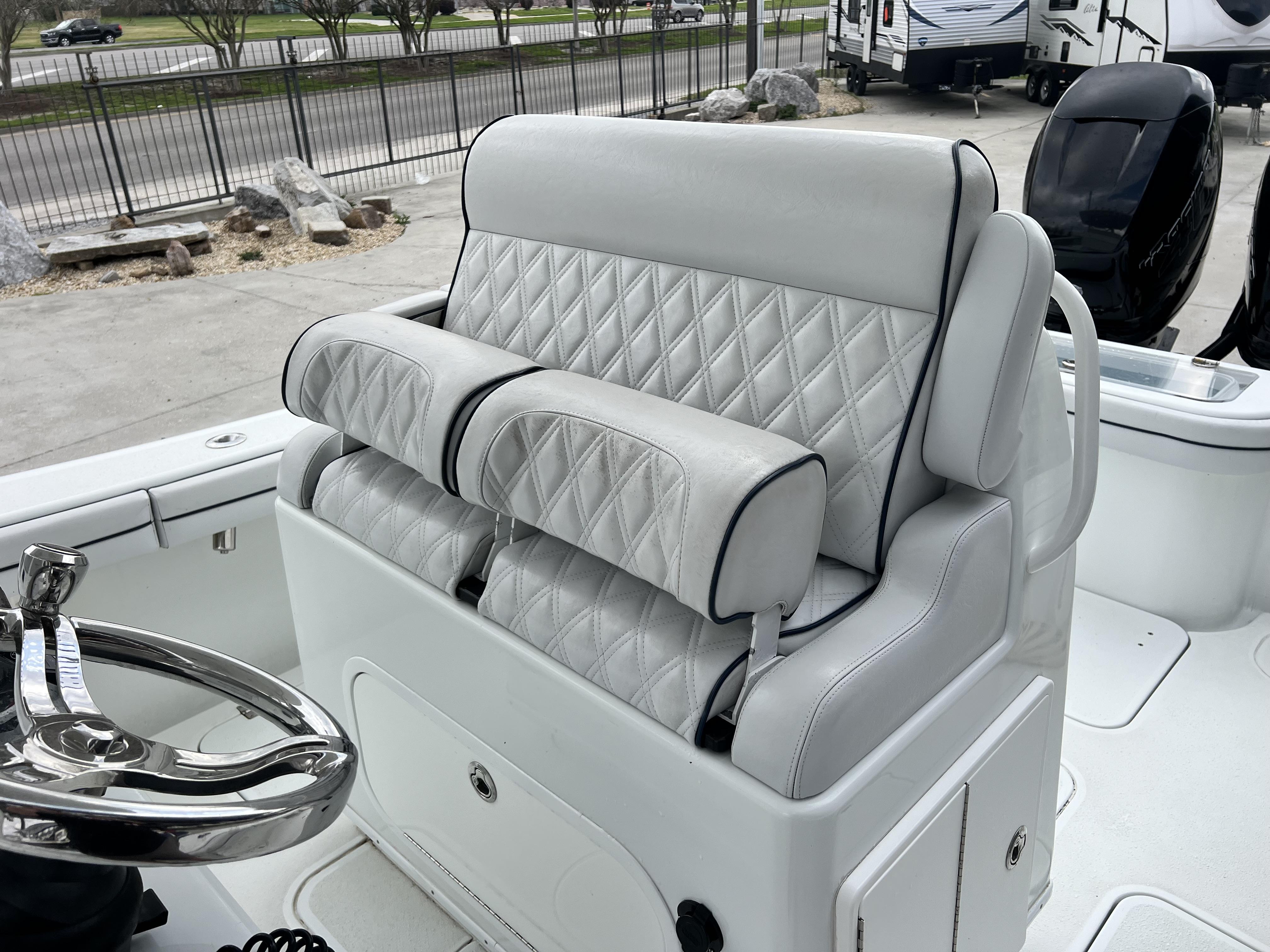 Slide: The Image of 2018 Yellowfin 29 boat with diamond-stitched white leather seating and chrome steering wheel. - 35