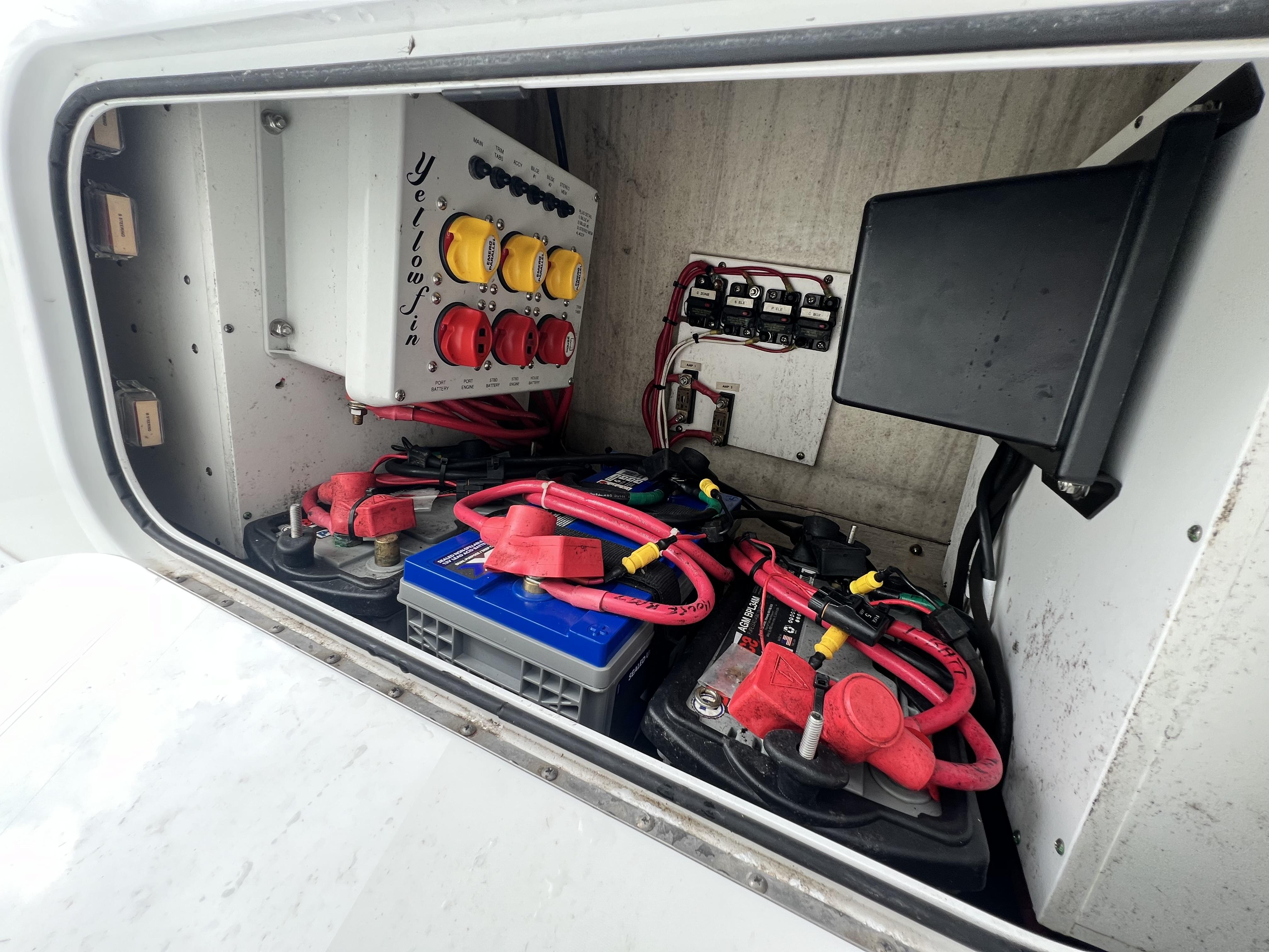 Slide: The Image of Electrical compartment of a 2018 Yellowfin 29 boat with batteries and wiring. - 36