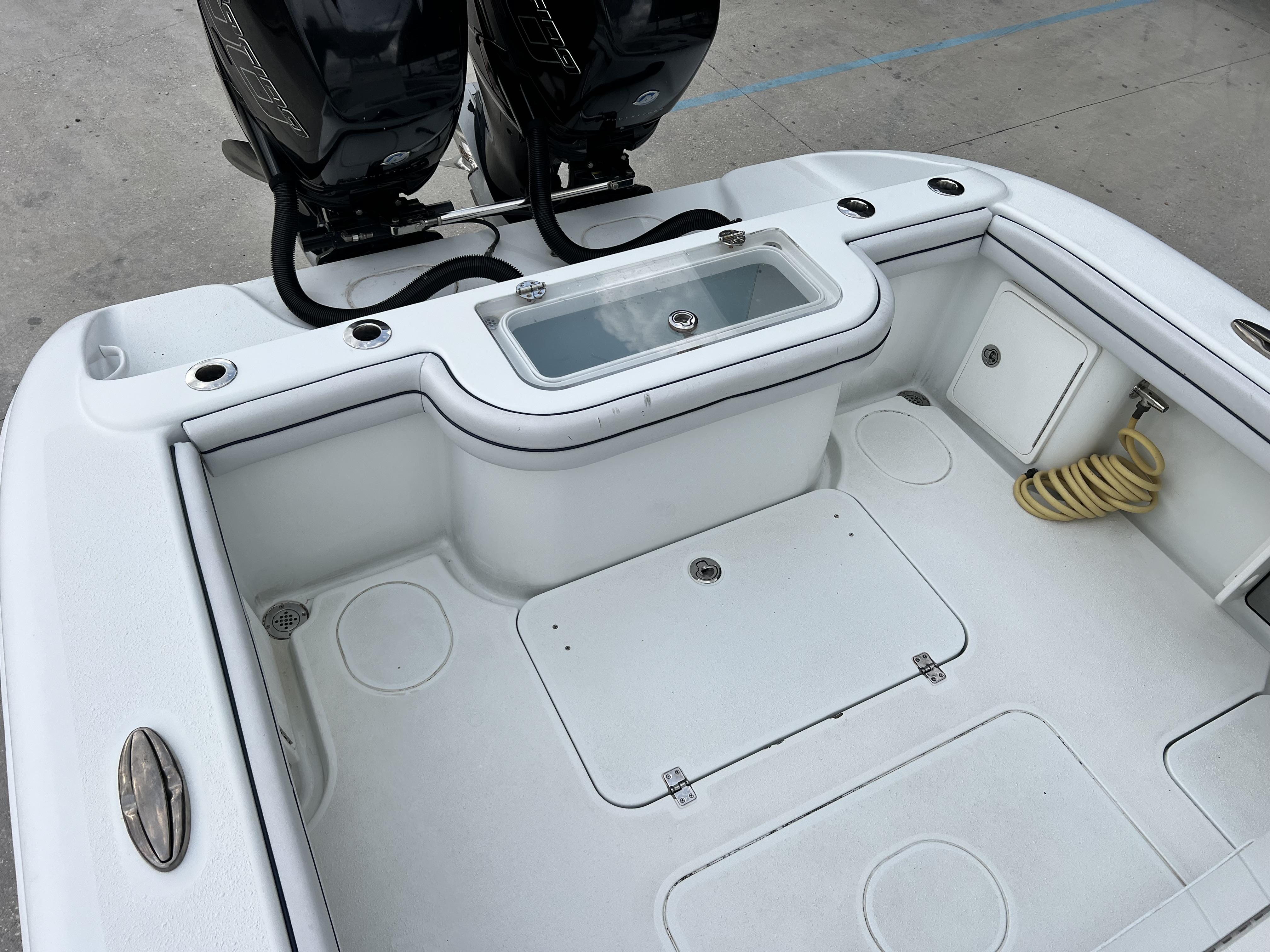 Slide: The Image of 2018 Yellowfin 29 boat deck with twin outboard engines and storage compartments. - 37