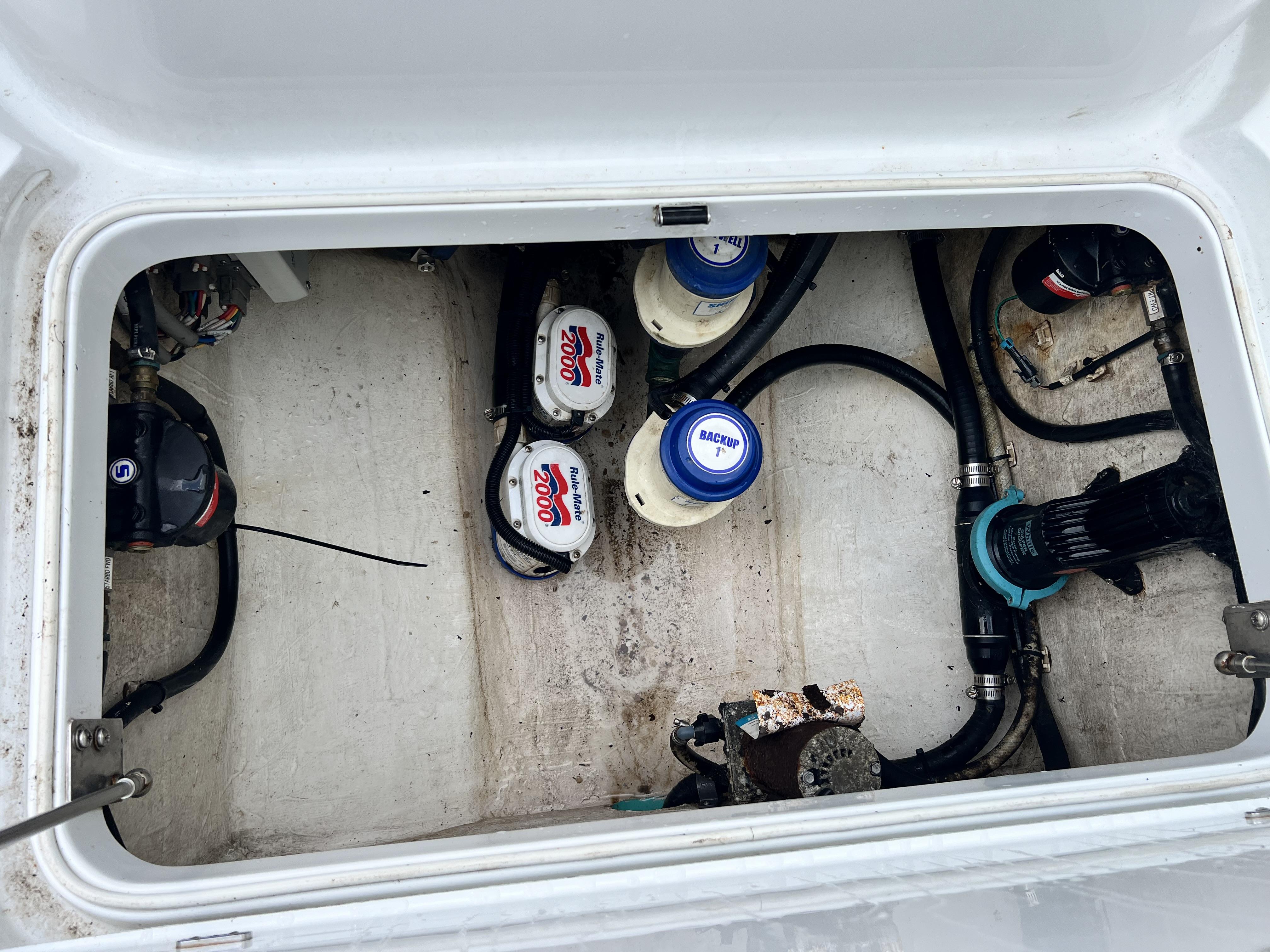 Slide: The Image of 2018 Yellowfin 29 boat bilge area with pumps and wiring. - 38