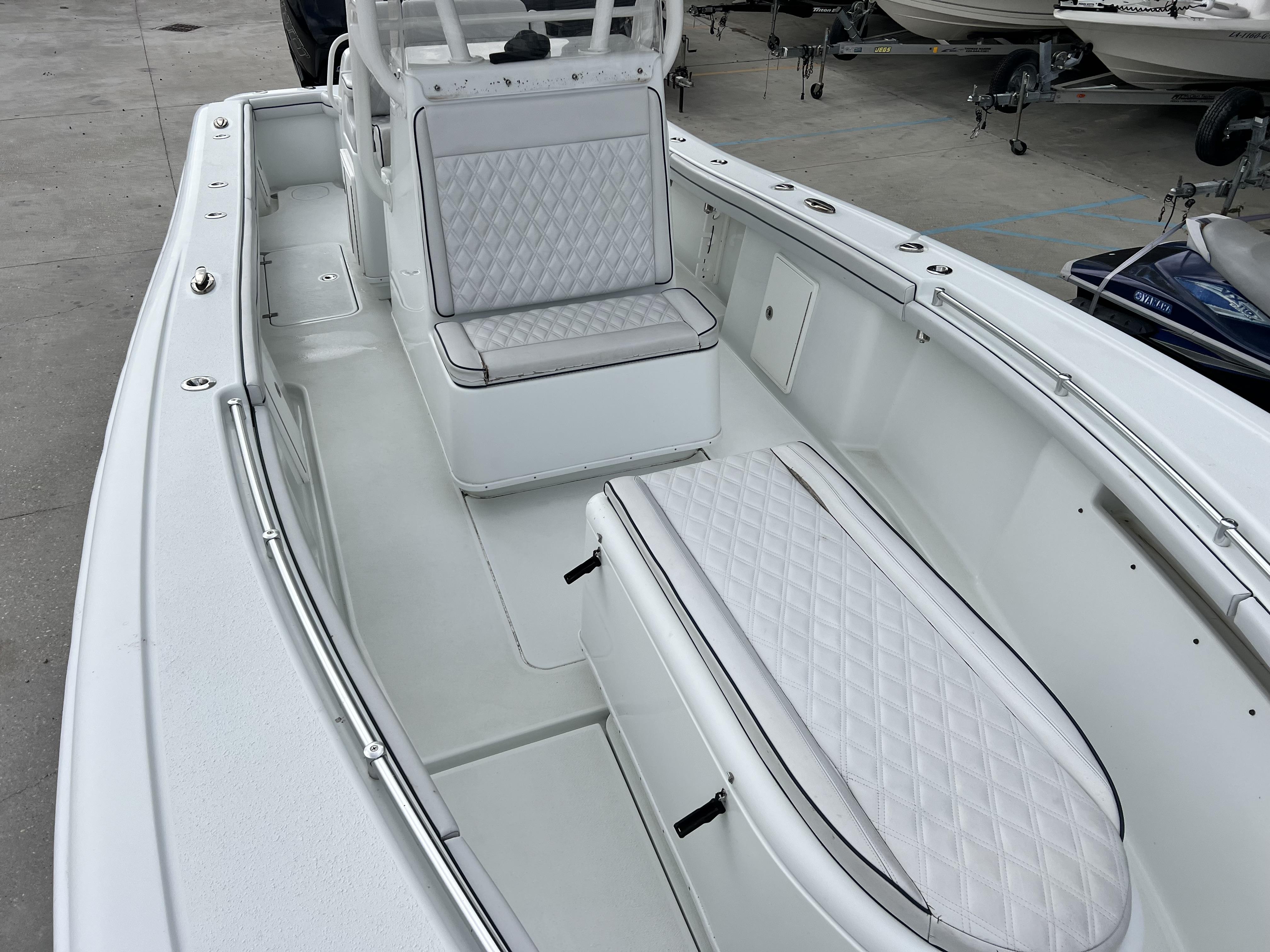 Slide: The Image of 2018 Yellowfin 29 boat interior with white cushioned seating. - 9